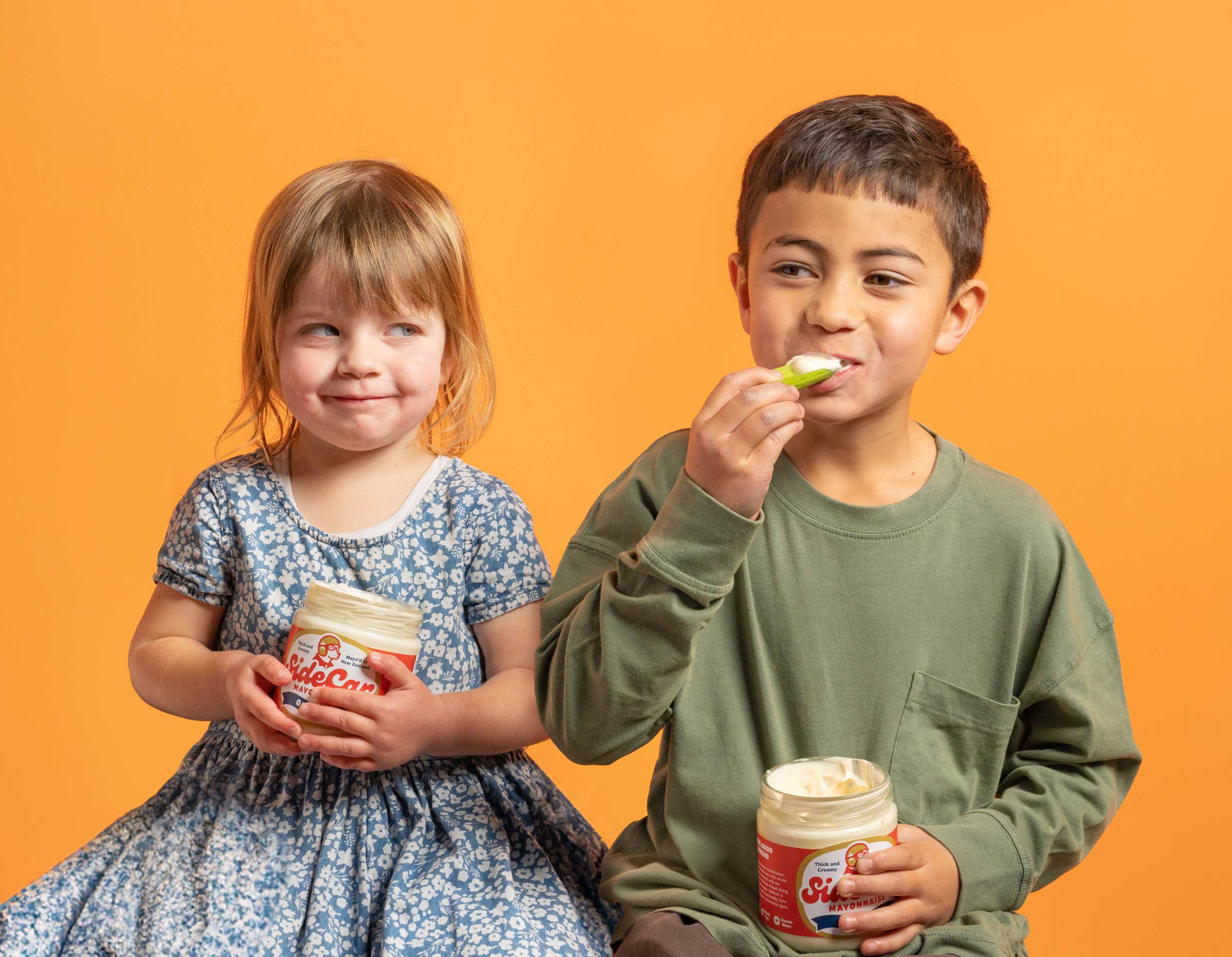 Two kids eating mayo from the jar