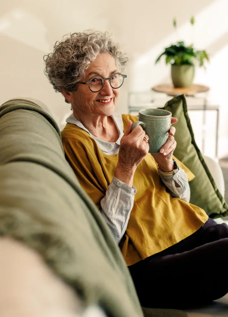Smiling older woman enjoying tea