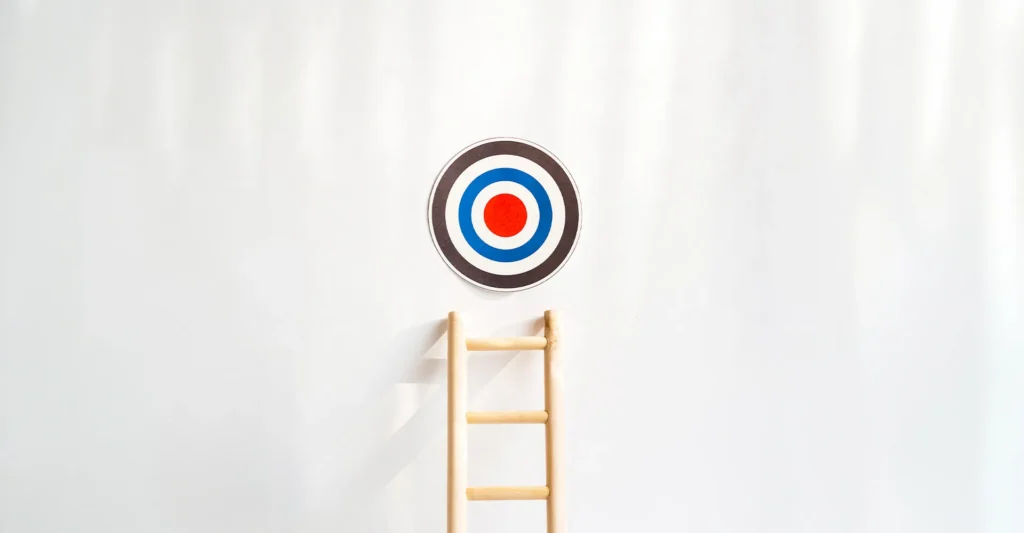 Target on wall with ladder representing brand positioning