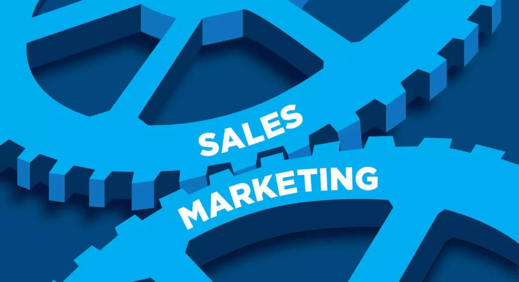 Interlocking gears labelled sales and marketing - sales functions vs marketing strategy alignment responsibilities