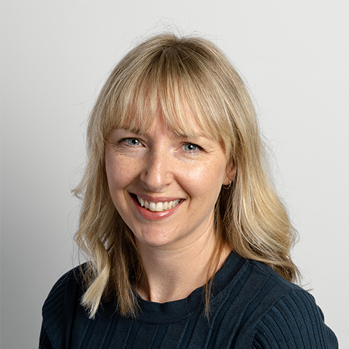 Studio portrait of Annabelle, Senior Creative at Downing, smiling with blonde hair.