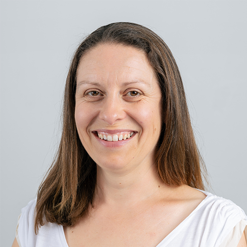 Studio portrait of Claire, Office Manager at Downing, smiling against a light background.