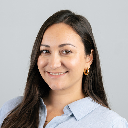 Studio portrait of Oriwa, Marketing Manager at Downing, smiling against a neutral studio backdrop.
