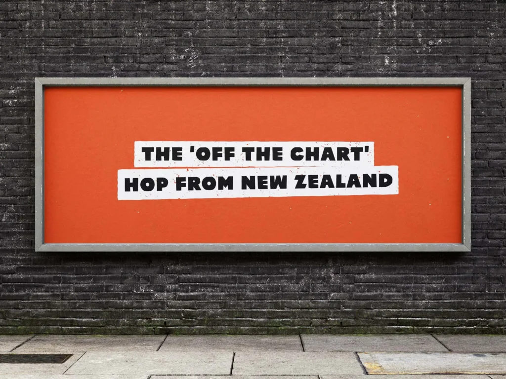 Orange campaign wall billboard with white text reading "THE 'OFF THE CHART' HOP FROM NEW ZEALAND" for Clayton Hops.
