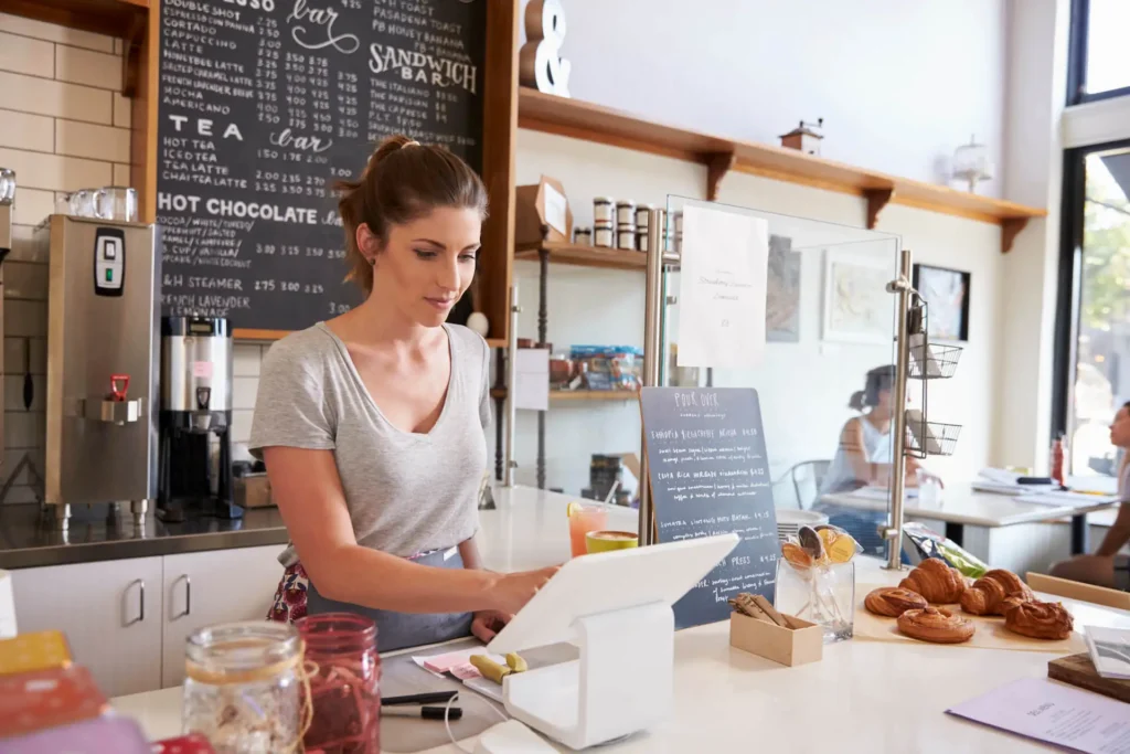Barista working at coffee shop counter - locally-owned New Zealand business brand value proposition