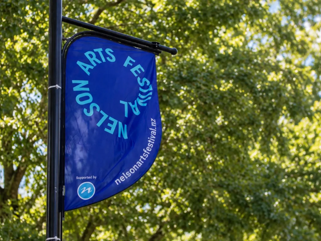 Nelson Arts Festival brand identity on a street banner, Trafalgar Street, Nelson