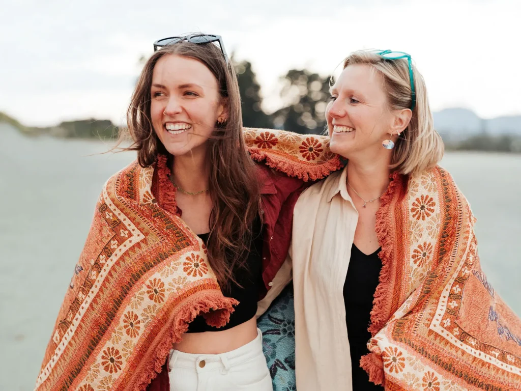 Two women smiling with shawls
