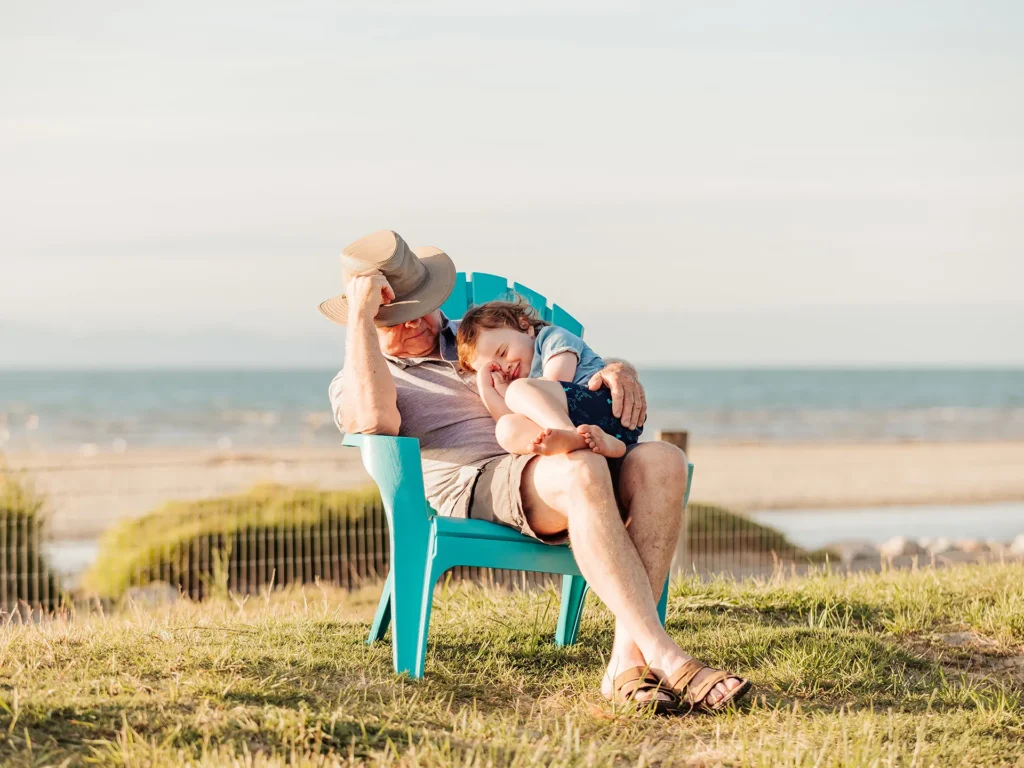 Grandad and child enjoying seaside together.