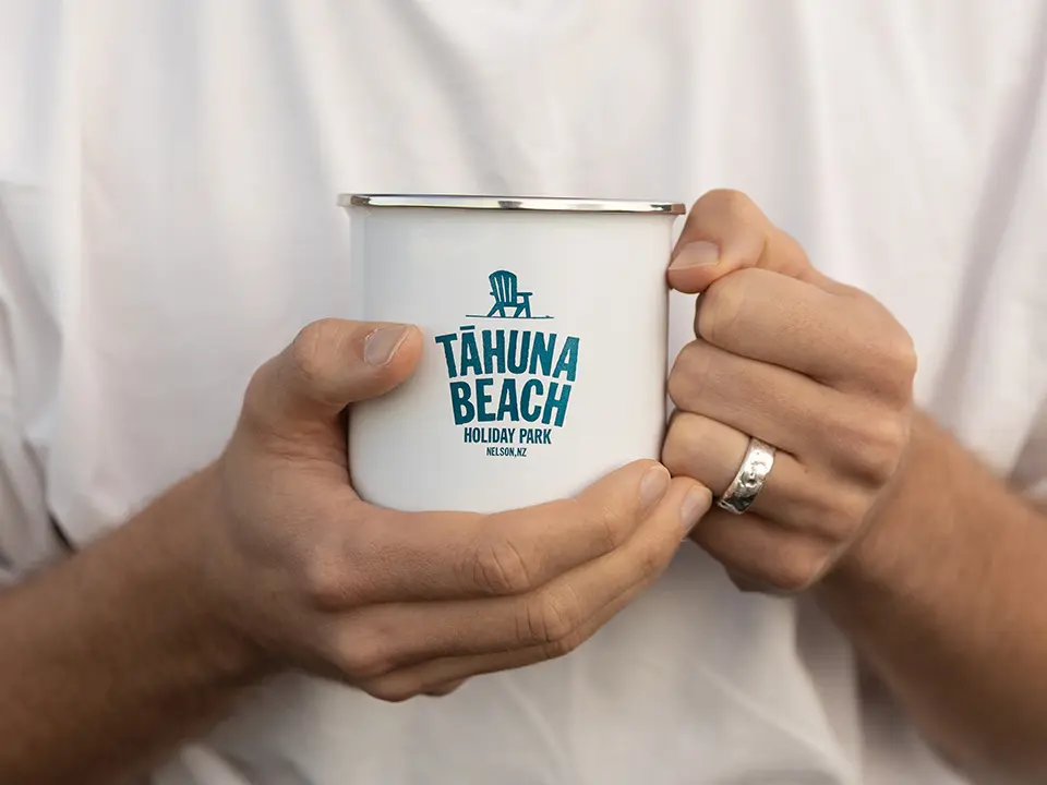 Tāhuna Beach Holiday Park branded enamel mug